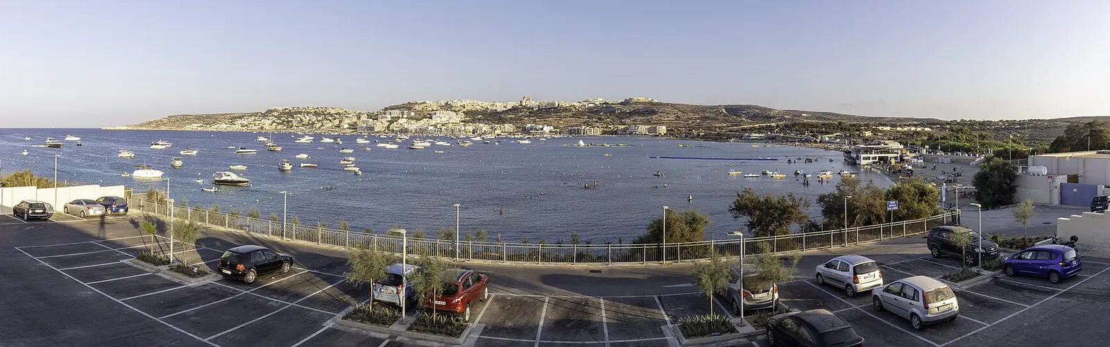 Mellieħa Bay seen from the car park above it, with the town on the hillside beyond